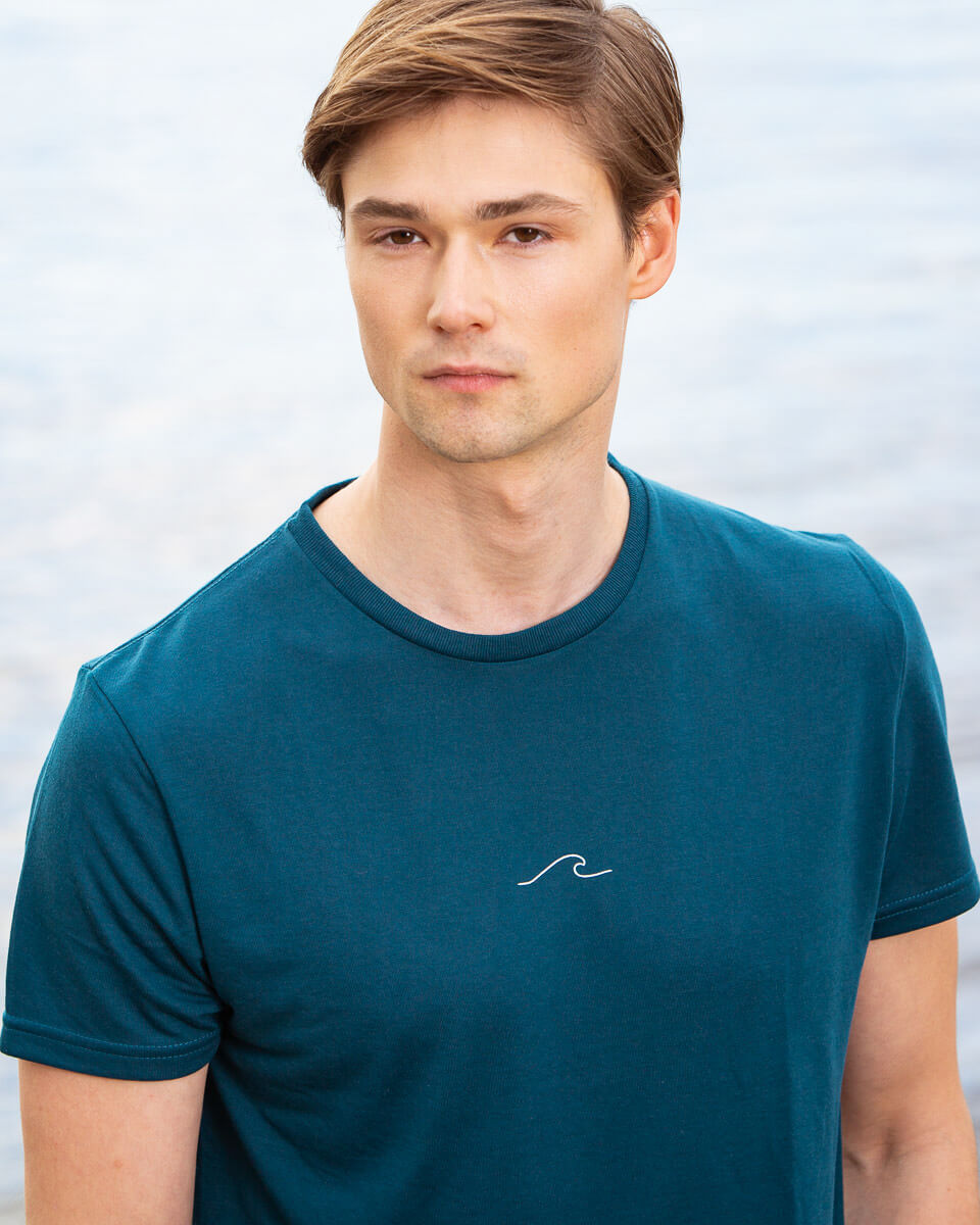 Model posing in Men's Eco Oceanness T-shirt in Ocean Green