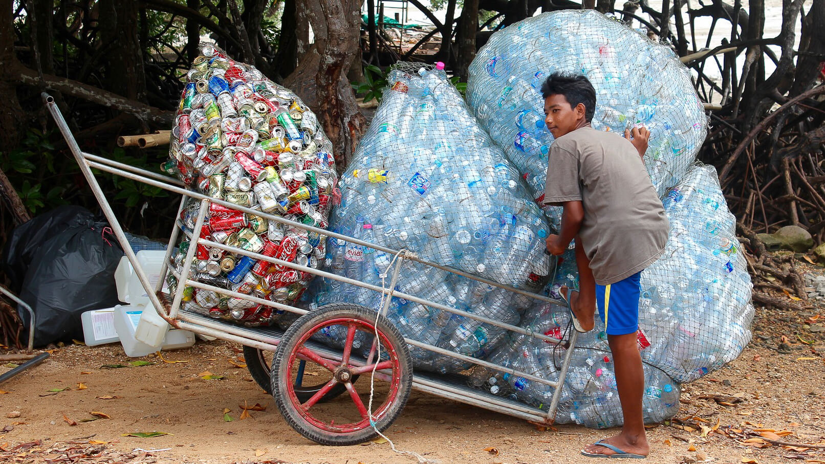 Oceanness person collecting ocean-bound plastic bottles
