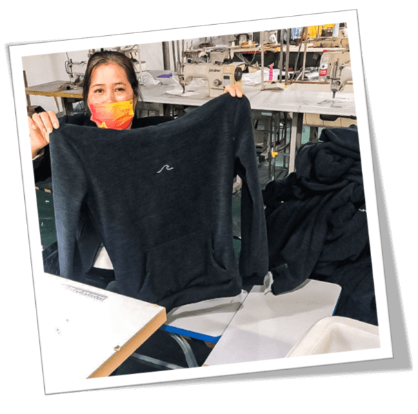 Oceanness employee proudly showing ethical eco-friendly hoodie