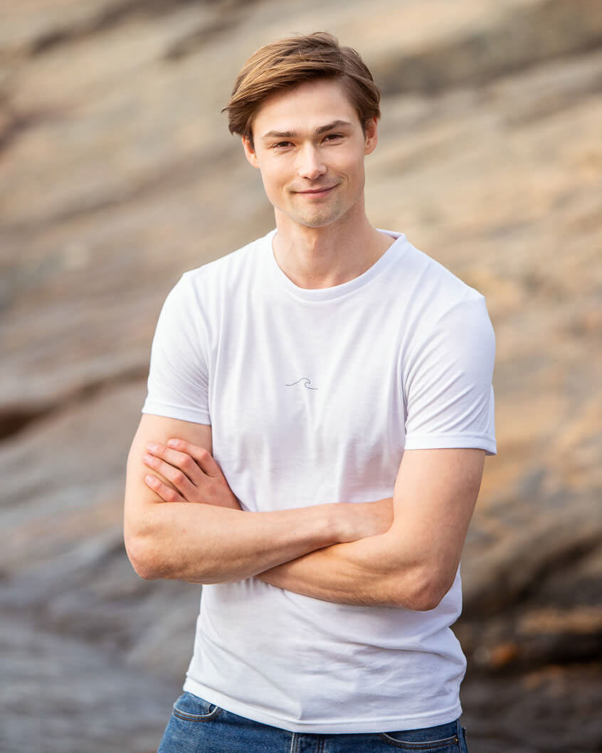 Model posing in Men's Eco Oceanness T-shirt in Arctic White